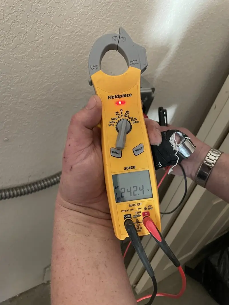 Voltage testing with clamp meter during Whole House Surge Protector in Centre